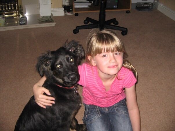 A photo of a young Caitlin and a collie cross puppy, Sophie.